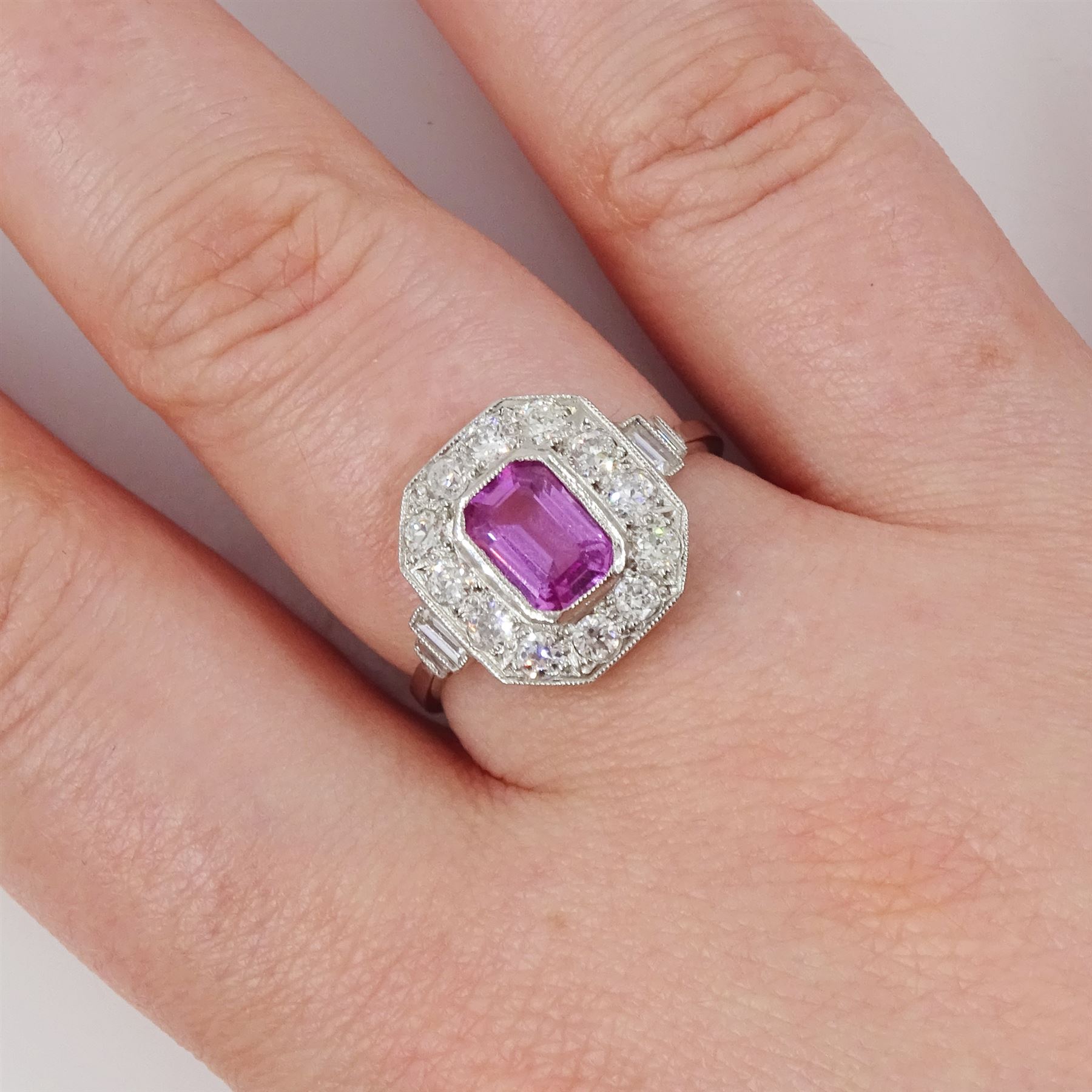 Platinum pink sapphire and diamond milgrain set cluster ring, single octagonal cut sapphire of approx 0.95 carat, surrounded by twelve old cut diamonds, with baguette cut diamond shoulders, stamped Plat, total diamond weight approx 0.70 carat