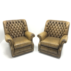 Pair Pegasus armchairs upholstered in deeply buttoned antique brown leather, W85cm