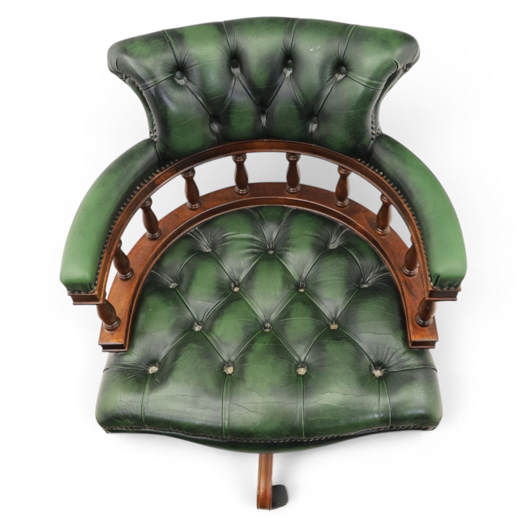 Captains swivel desk chair upholstered in buttoned green leather, five point star base raised on castors