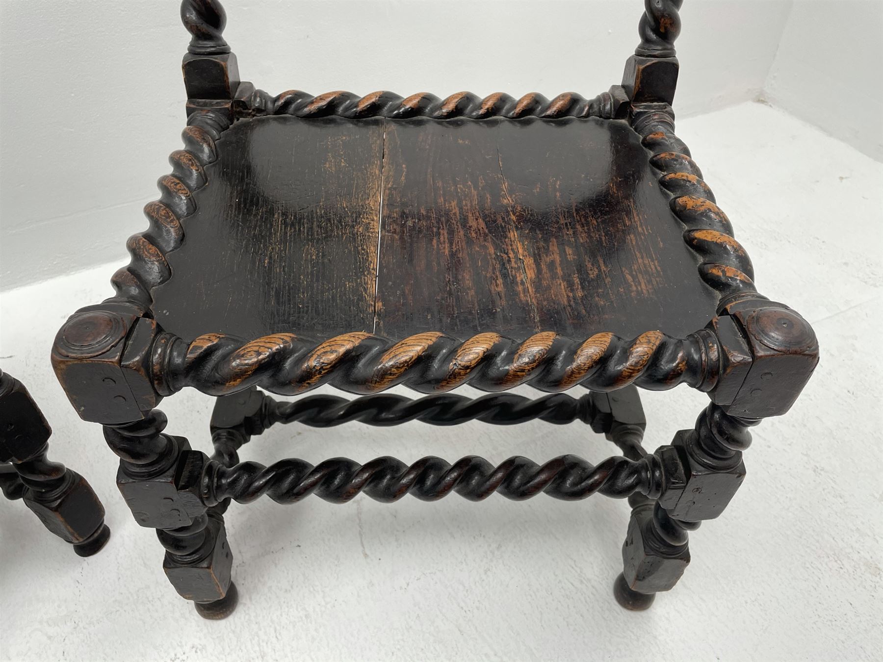 Unusual pair late 17th century oak spindle-back chairs, barley twist or spiral turned throughout, the back with a row of six vertical turned spindles, the supports joined by two lower rails and front central rail, plank seats

Provenance - The chairs illustrated in 'Early British Chairs and Seats 1500-1700' by Tobias Jellinek (Pub: Antique Collectors Club. 2009. p 313). Previous part of a private collection. Vendor purchased from auction 2014.

Measurements - seat width - 48cm, seat height - 38cm/36cm, depth - 50cm, total height - 85cm/82cm