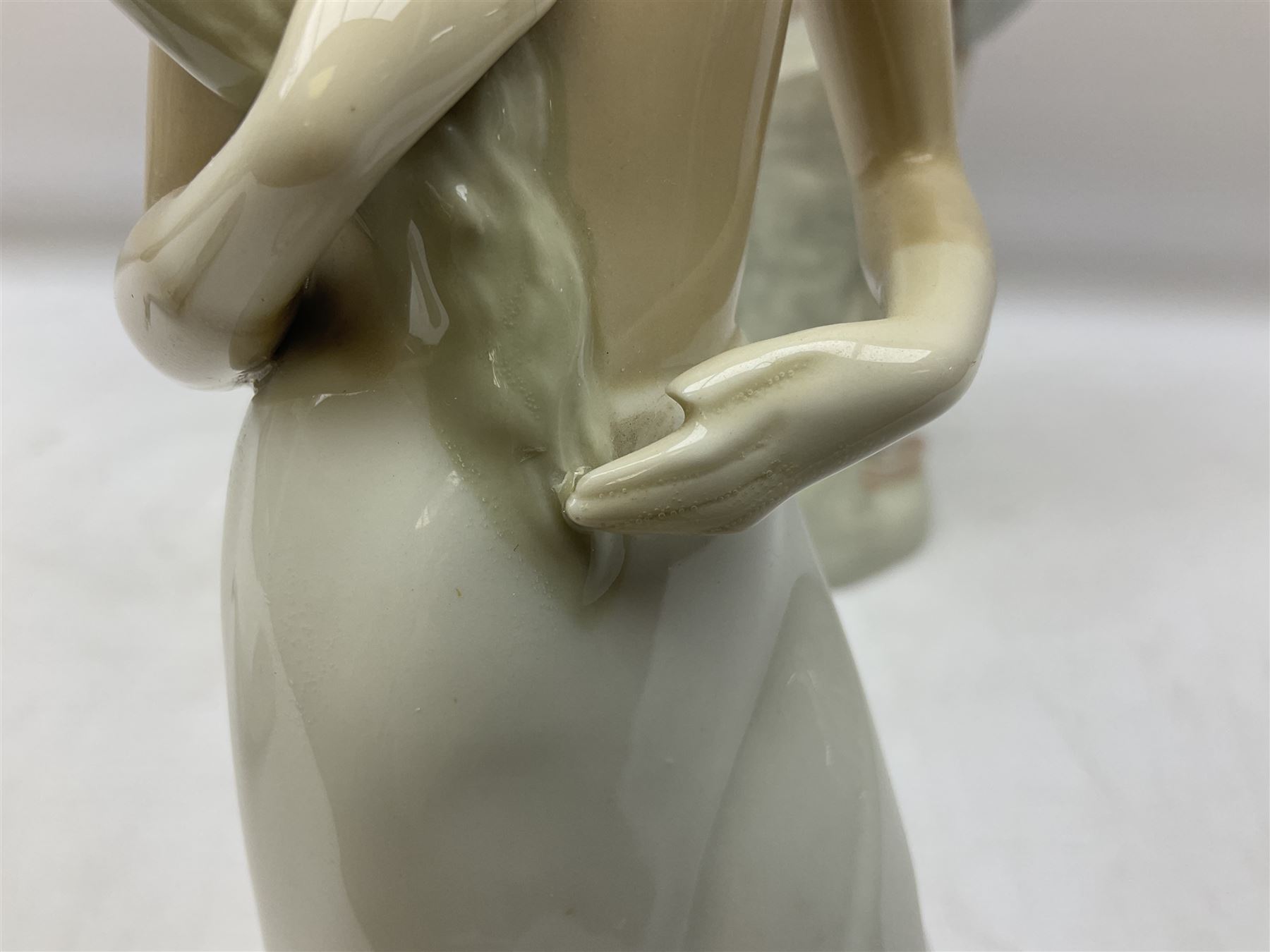 Lladro 'Walk With the Dog' figure no. 4893, together with Lladro swan figure, Porceval figure of a gentleman with a bird perched upon his hand and a further of a lady with flowers beside a basket, all with marks beneath, tallest H40cm