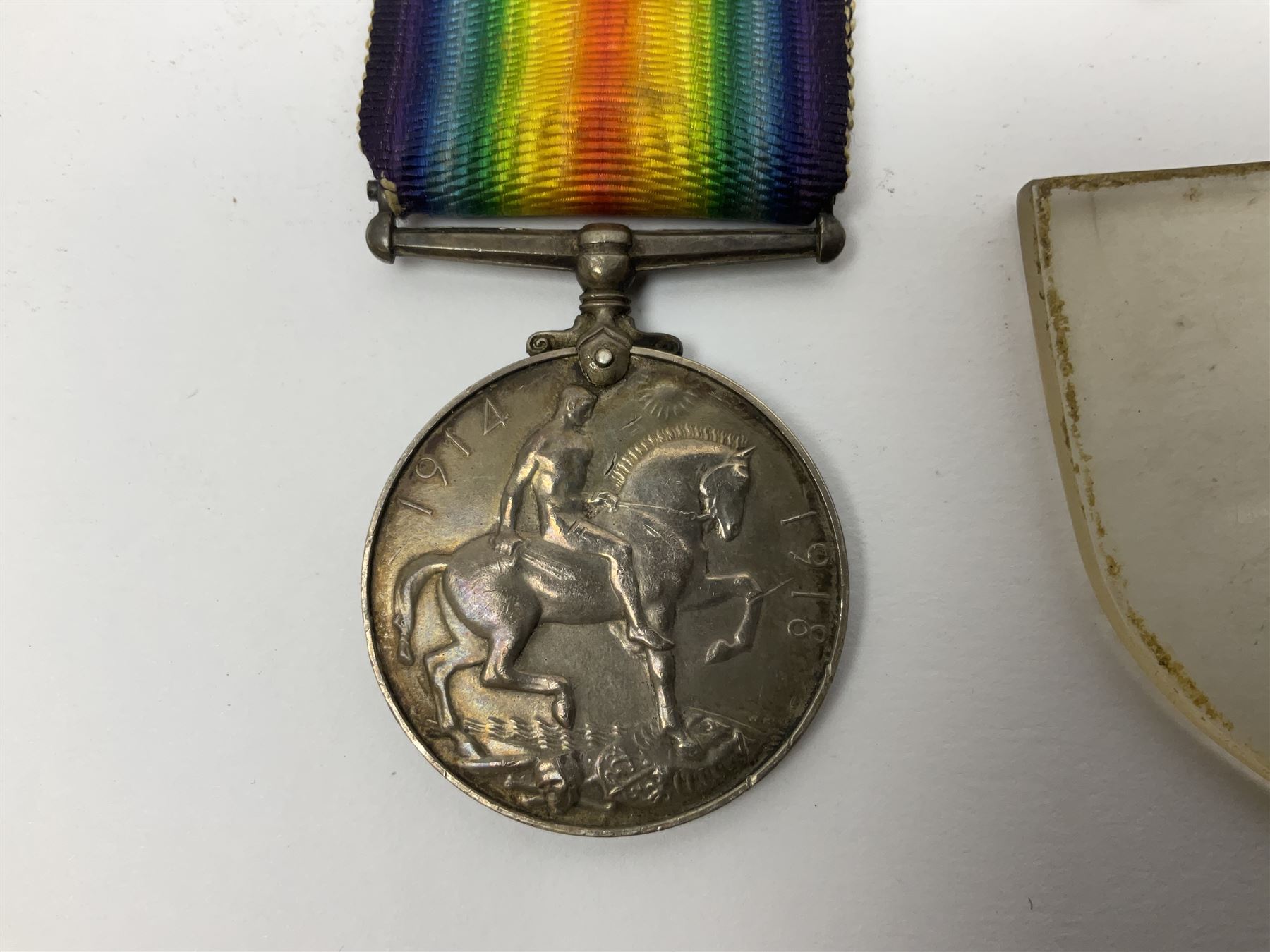 WW1 pair of medals awarded to 151761 Gnr. S. Loten R.A. with ribbons; four WW2 medals with ribbons; and small quantity of cap badges, medallions etc