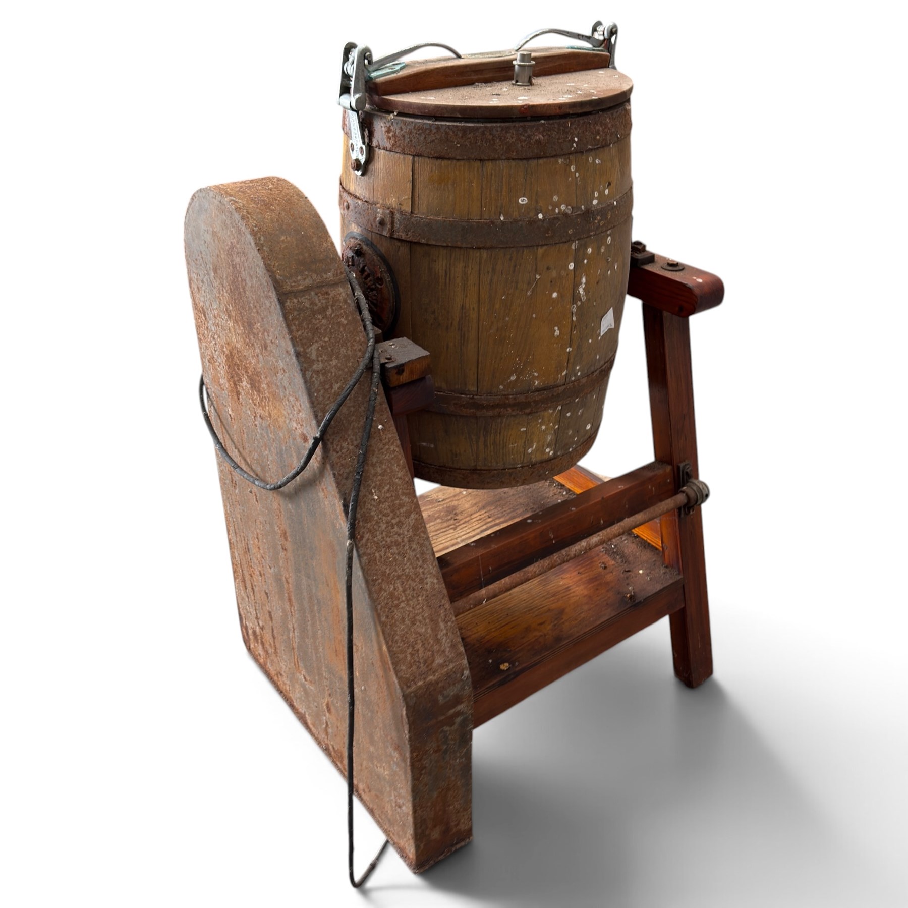 Two early 20th century dairy equipment items: Waide & Sons, Leeds – oak barrel butter churn with iron bands, later converted to electric operation, on trestle stand (W71cm H115cm); Lister – ‘Ball Bearing’ cast iron cream separator, with hopper and foot pedal, in red-painted finish (W47cm H49cm)