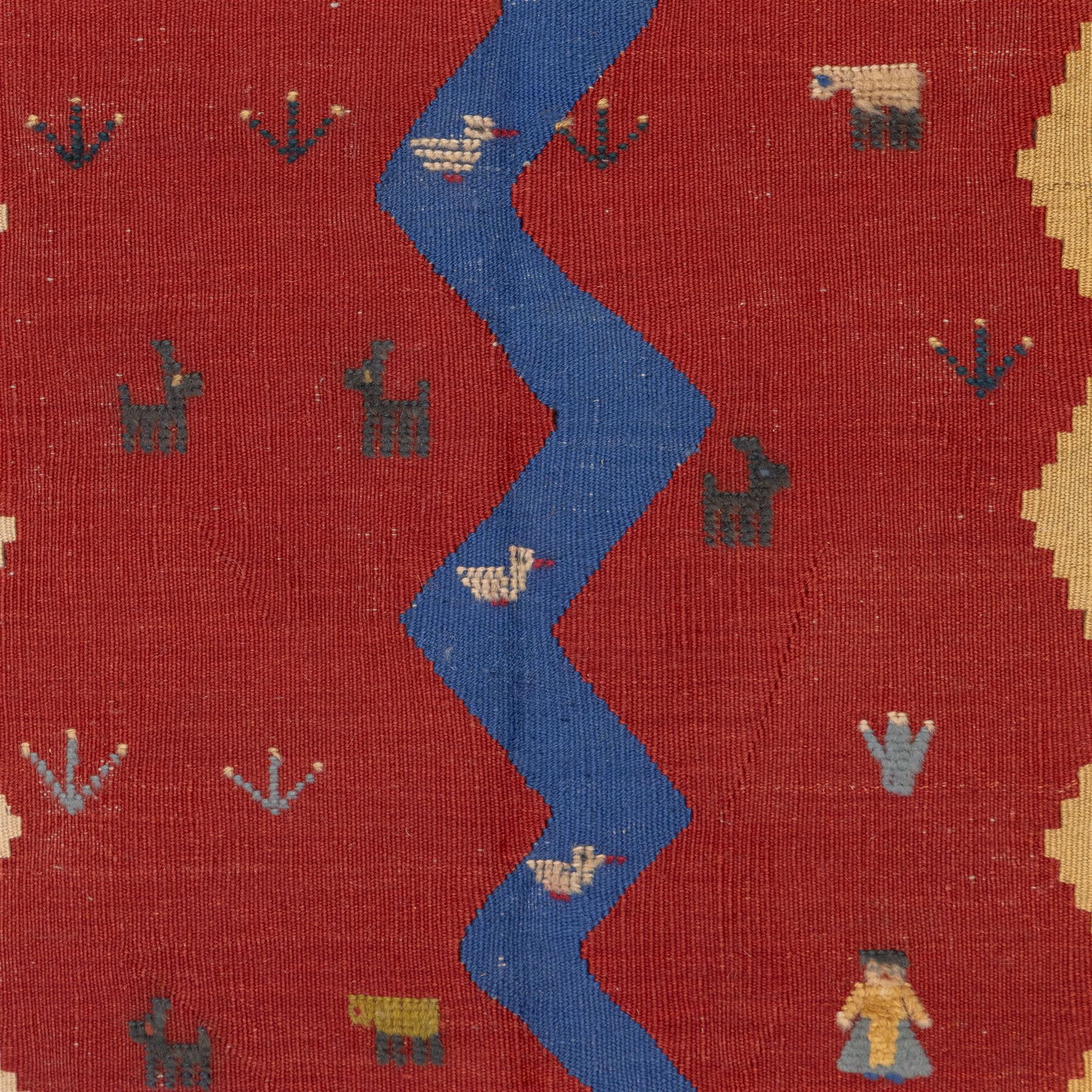 South West Persian Qashqai pictorial flatweave kilim, with central sinuous indigo river band dividing broad panels of madder red and camel yellow, red ground sparsely decorated with stylized animals, birds, and schematic shrubs, executed in bold geometric idiom, with fringe ends 