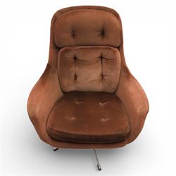 Pair of mid 20th century brown velvet swivel lounge chairs and matching footstool, the shaped and padded back with buttoned segmented cushion over conforming seat cushion, flared armrests and moulded sides, raised on a five point metal swivel base, the footstool en suite with buttoned cushion and matching metal base