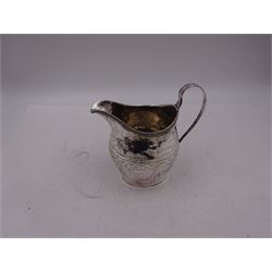 George III silver cream jug, of helmet form, with C scroll handle and a band of engraved strapwork decoration and monogrammed initials to body, hallmarked London 1802, maker's mark SA probably Stephen Adams I, including handle H10.4cm