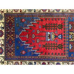 Turkish Yuruk indigo ground rug, the field decorated with geometric architectural designs, the guarded ivory border with repeating stylised plant motifs
