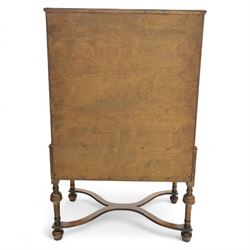 Georgian style walnut chest on stand, the figured top section fitted with four long drawers above a further drawer on the base, brass swan-neck handles, on turned legs joined by shaped stretchers with bun feet