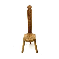Heavily carved oak milking stool, turned supports 