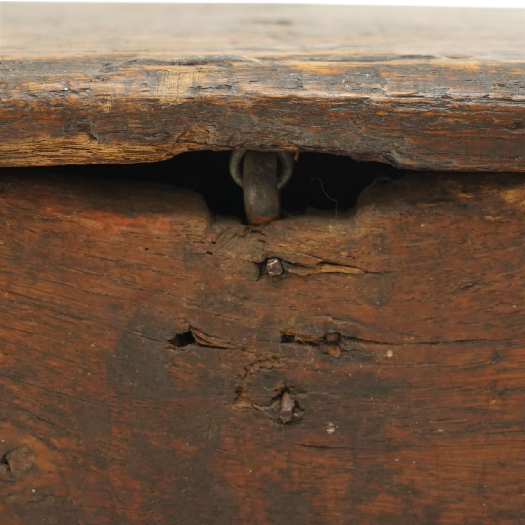Small 17th century six plank oak coffer, figured top with iron pintle type hinges,  pegged boarded sides, large lock plate with rivets, plank ends continuing down as supports