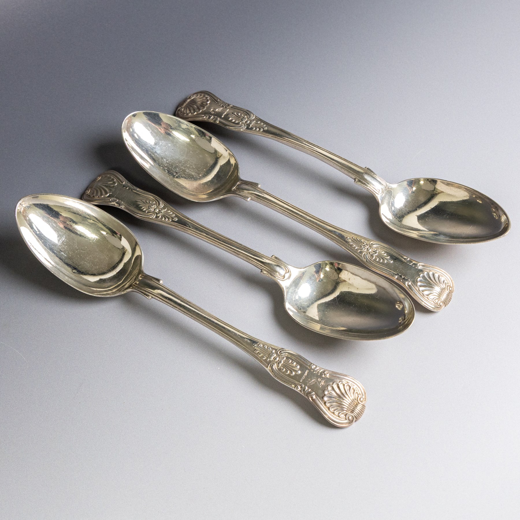 Four silver Kings pattern table spoons, comprising George IV pair, engraved with stork and serpent crest, hallmarked William M Traies, London 1827 and a Victorian pair, hallmarked Mary Chawner, London 1838