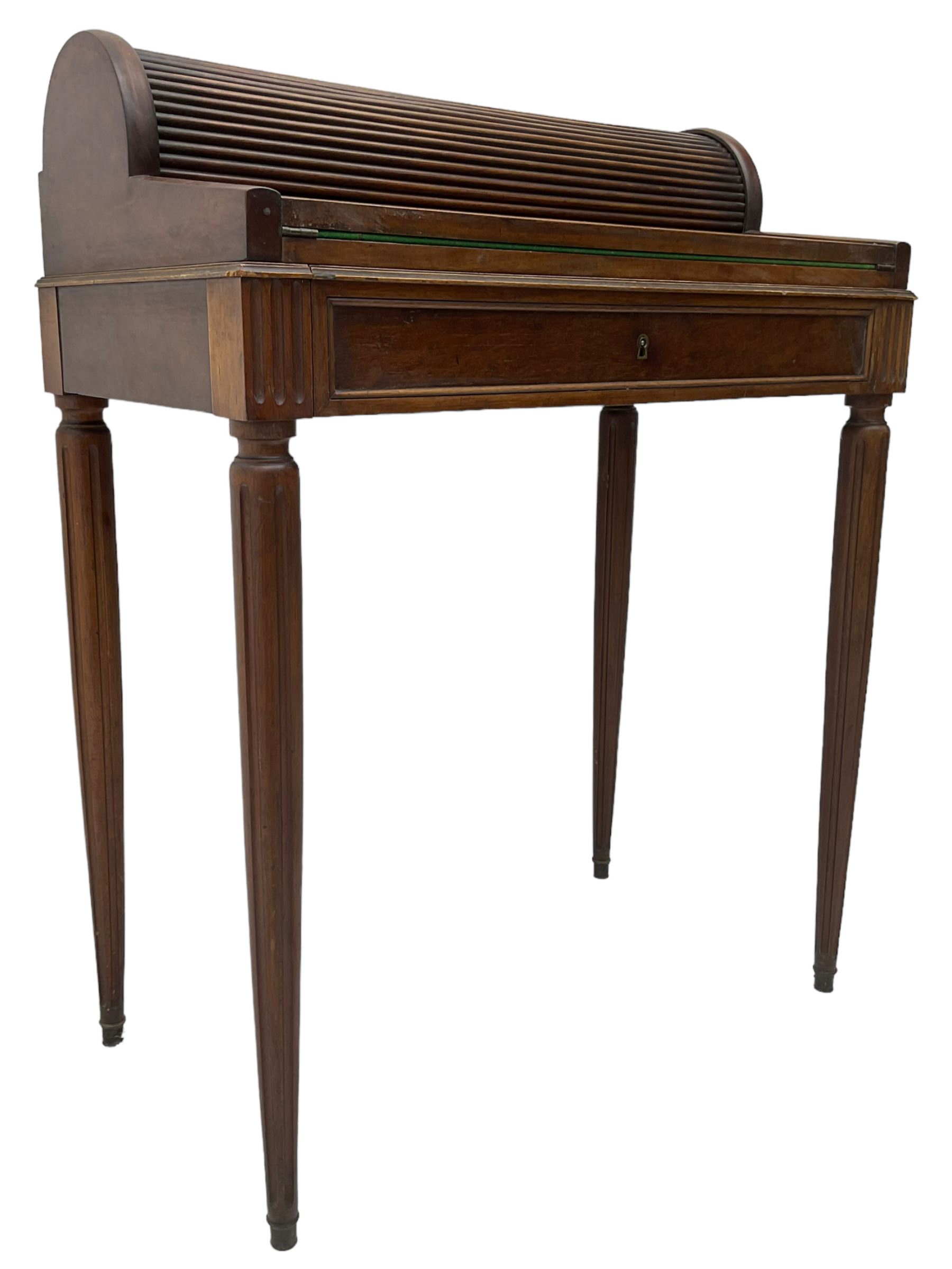 Early 20th century French plum pudding mahogany petite writing desk, barrel tambour roll top, fitted with a single cock-beaded drawer activating the tambour roll, the fold-over writing slope with inset writing surface supported by long drawer, fitted with three small drawers and pen rail, raised on fluted tapering supports