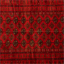 Turkman hand-knotted carpet, deep red ground, with an all-over field of repeating gul motifs arranged in rows, enclosed by multiple red geometric borders with stylised flowerheads and hooked motifs, flanked by narrow patterned guard stripes, with wool fringes