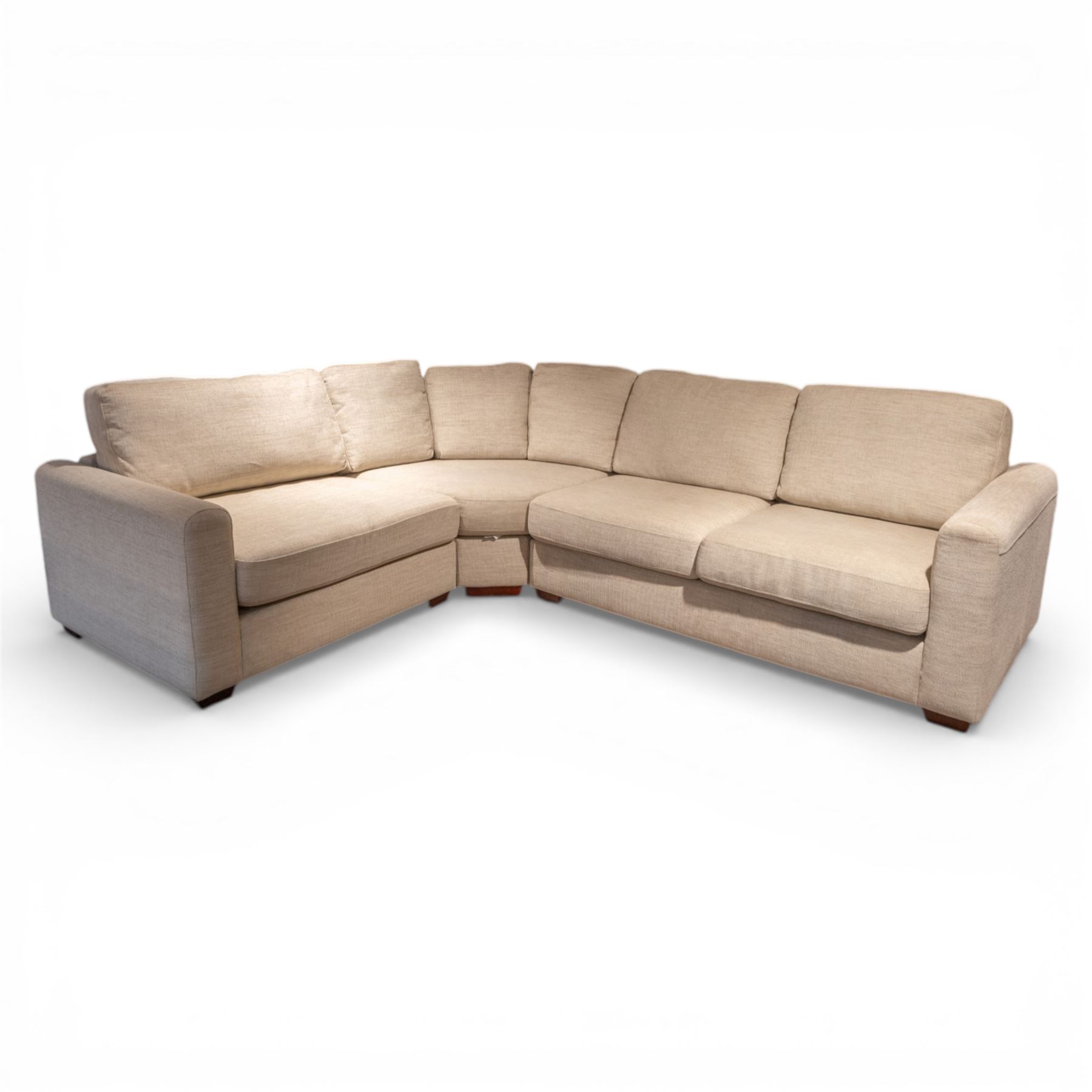 Contemporary modular corner sofa, upholstered in neutral fabric, with curved back fitted with loose cushions and wide seat pads, padded scroll arms and block feet, designed as three detachable sections