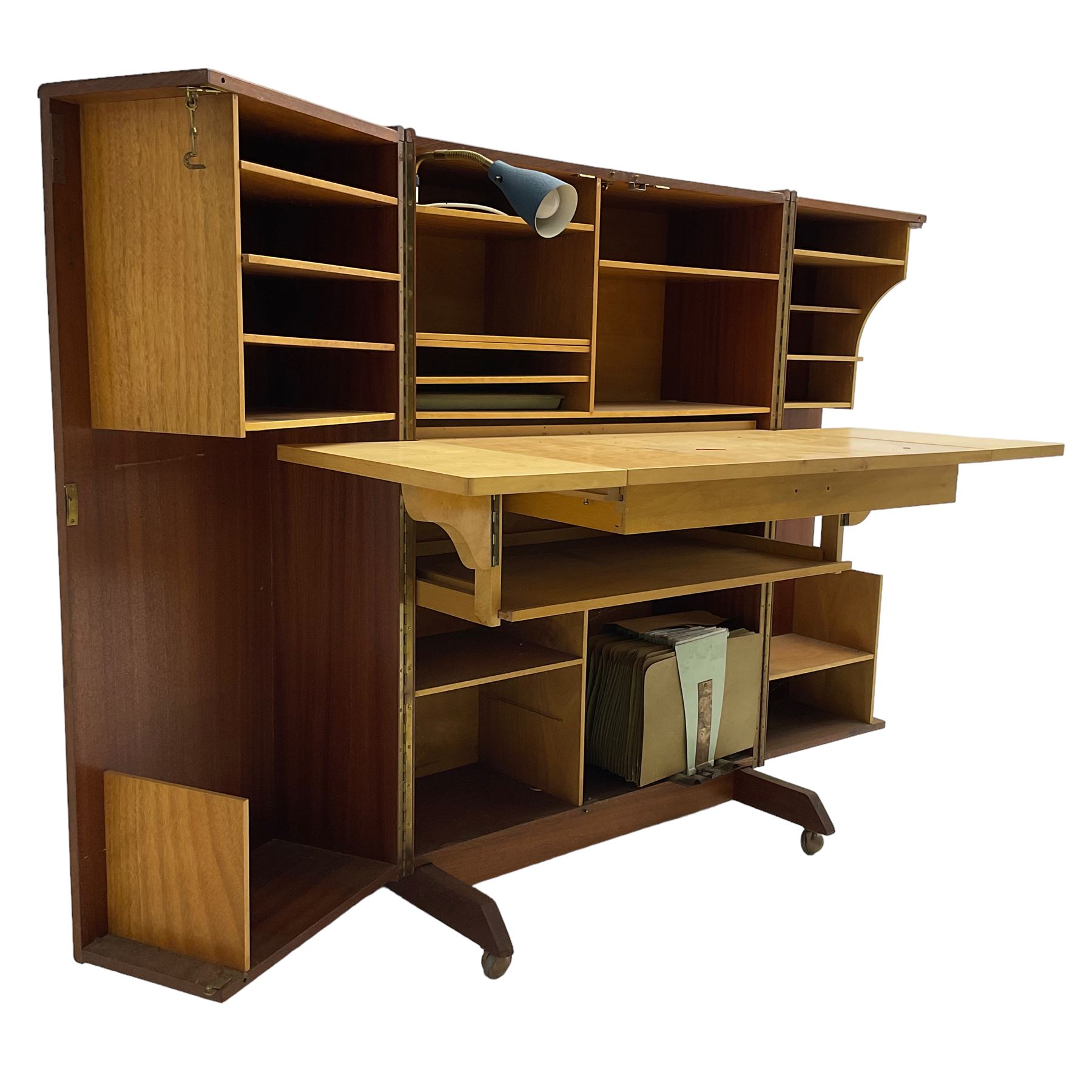 Mummenthaler & Meier - mid-20th century circa. 1960s teak 'Magic Box' folding desk cabinet, the cabinet opens to reveal shelves, writing desk, document holders and lamp, on castors