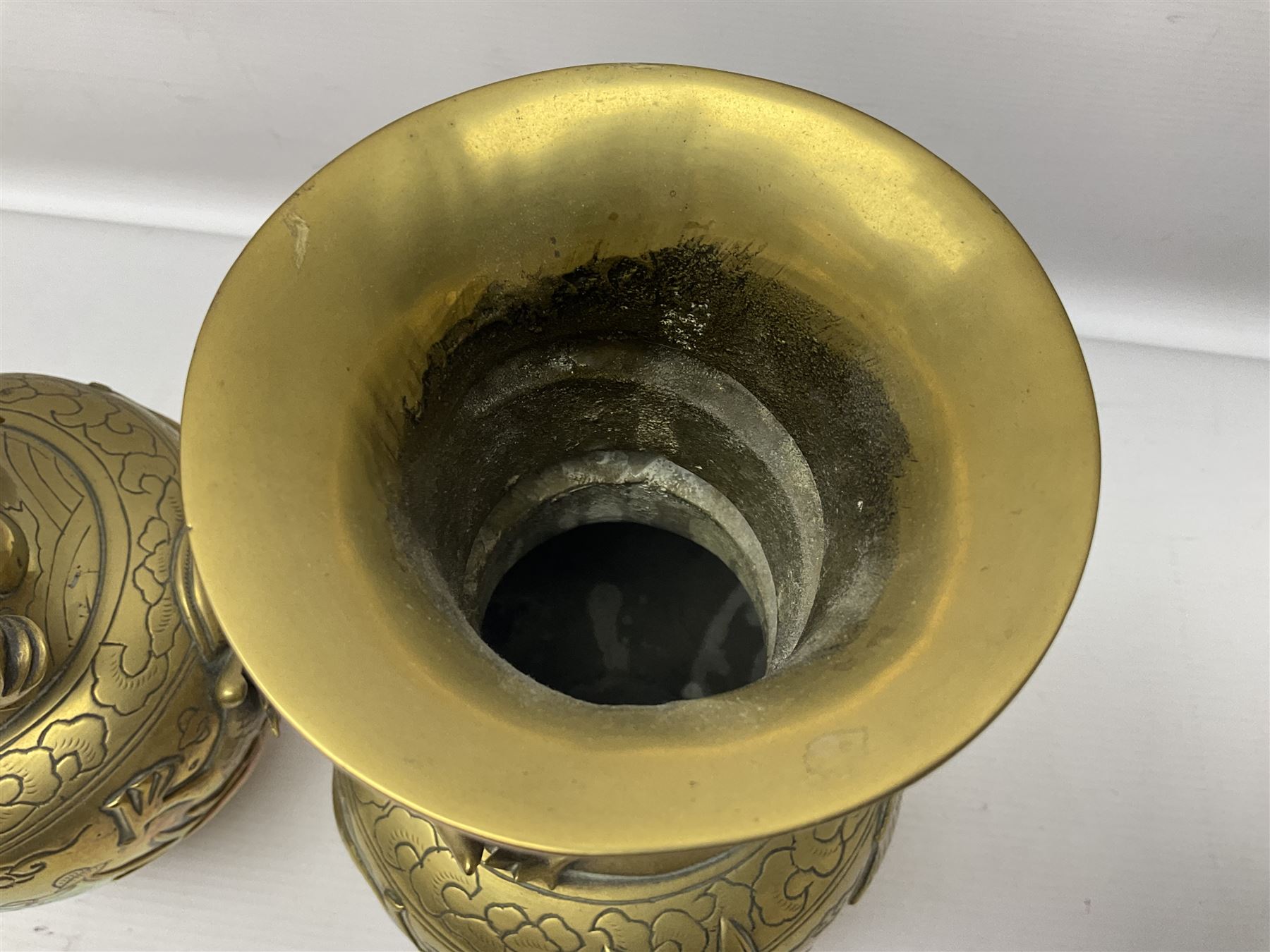 Pair of Chinese brass vases, of ovoid form with elongated neck and fluted rim, decorated in high relief with a dragon chasing a flaming pearl around the neck, the body with dragons, birds and buildings, with character marks beneath, H25cm