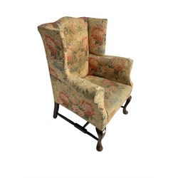 Early 20th century Georgian style wingback armchair, upholstered in floral fabric with sprung seat, walnut frame with front cabriole supports