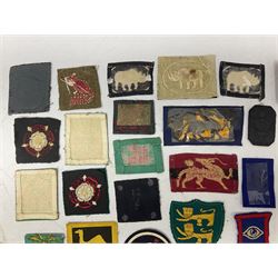 Approximately one-hundred printed and embroidered cloth badges including Royal Tank Regiment, Royal Armoured Corps, 219th Independent Infantry Brigade, Cyrenaica, Cyprus, Singapore and other districts, Gibraltar Garrison, East Anglian Brigade, 20th Armoured Brigade and various armoured divisions etc