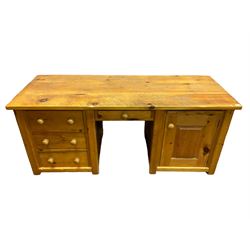 Large pine desk, rectangular top over four drawers, slide and panelled cupboard