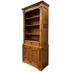 French cherry wood bookcase on cupboard, projecting moulded cornice over three shelves and two small drawers, the cupboard enclosed by two panelled doors flanked by fluted uprights