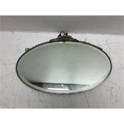 Wall mirror of oval form with stylised mount and bevelled plate, W56cm