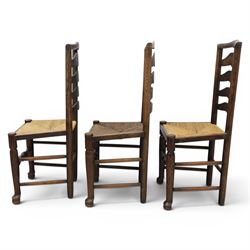 Set of seven (6+1) Georgian design country elm Lancashire dining chairs, ladder backs with rush seats, turned front leg stretcher on pad feet, height of seat 44cm, complete with fitted tie on cushions