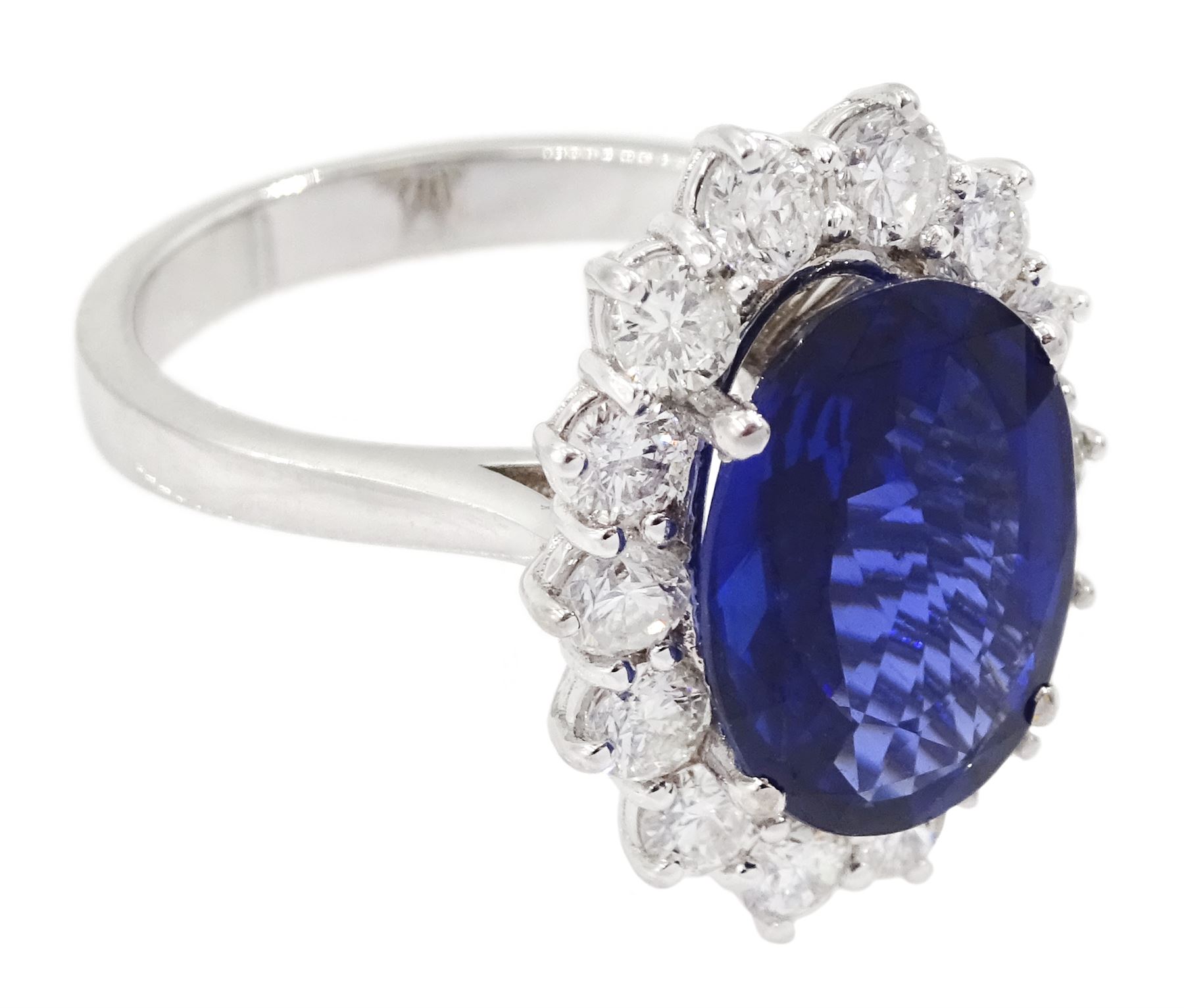 18ct white gold oval sapphire and round brilliant cut diamond cluster ring, hallmarked, sapphire approx 3.50 carat, total diamond weight approx 0.90 carat
