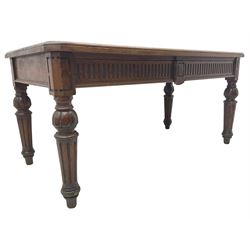 Late 19th century oak library table, moulded rectangular top with canted corners, fitted with two frieze drawers with fluted facias, on lobe carved and fluted turned supports 