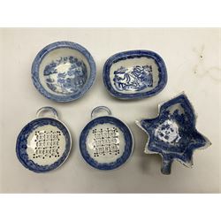 Two blue and white pearlware egg drainers, the pierced shallow bowls of circular form decorated with blue transfer printed floral border, together with an early 19th century pearlware blue transfer pickle dish in the form of a leaf, and two small shallow dishes decorated in willow pattern