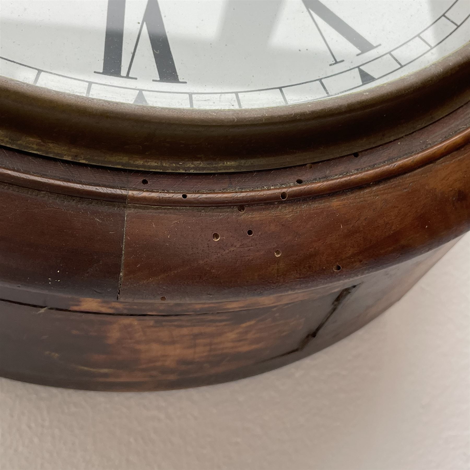 Early 20th century circular walnut cased wall clock, white enamel Roman dial, single train driven movement