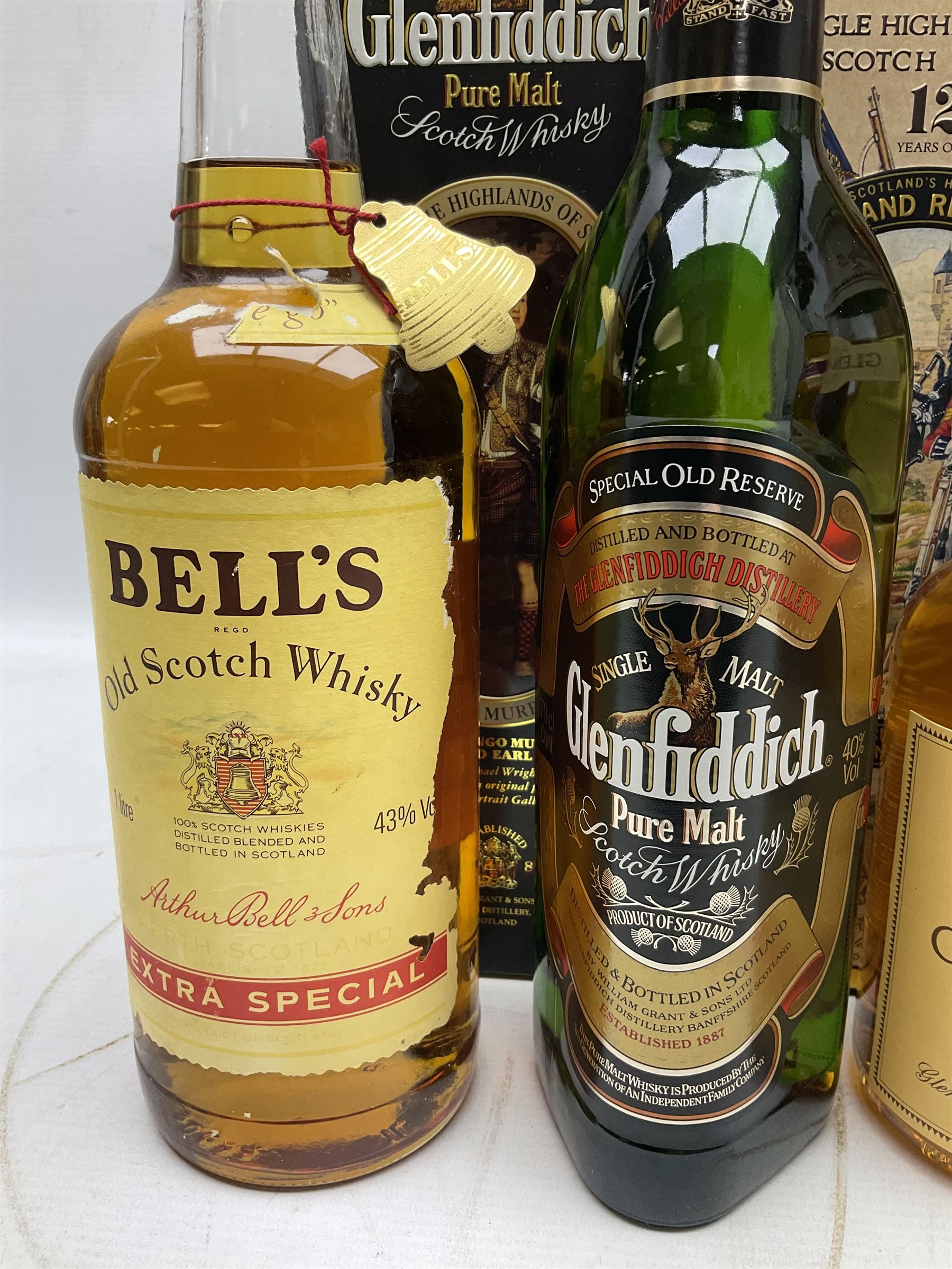 Glen Moray 12 Year Single Malt Highland Scotch Whisky, 70cl 40% vol, one bottle, in Highland Regiments The Black Watch presentation tin, Glenfiddich Pure Malt Scotch Whisky, Special Old Reserve, 70cl 40% vol, one bottle, in Clan Murray presentation tin, Bell's Extra Special Old Scotch Whisky, Aged 8 Years, 70cl 40% vol, one bottle, in box and Bell's Extra Special Old Scotch Whisky, 1l, 43% vol (4)