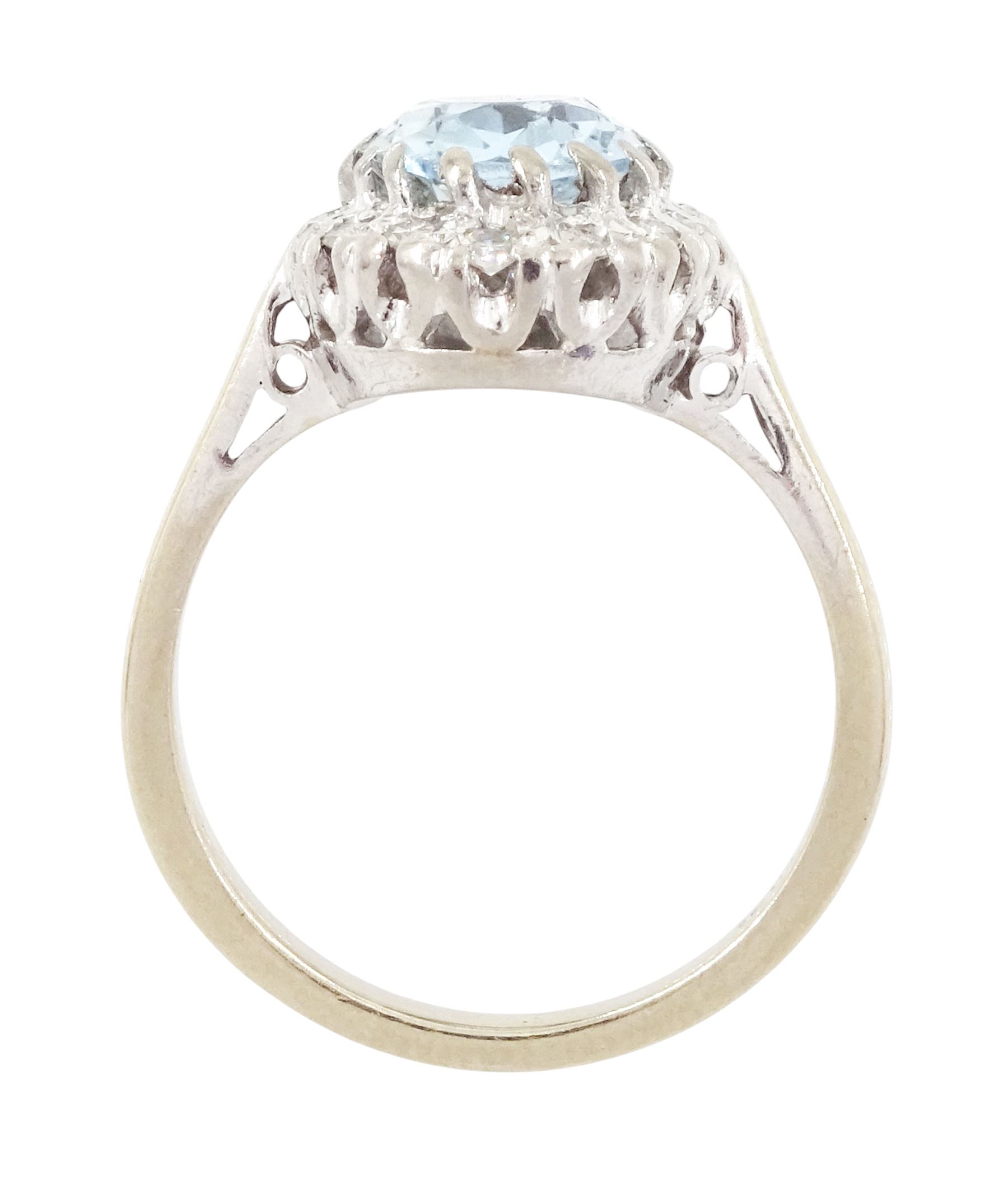 White gold aquamarine and diamond cluster ring, oval cut aquamarine of approx 1.35 carat, with single cut diamond surround, stamped 18ct