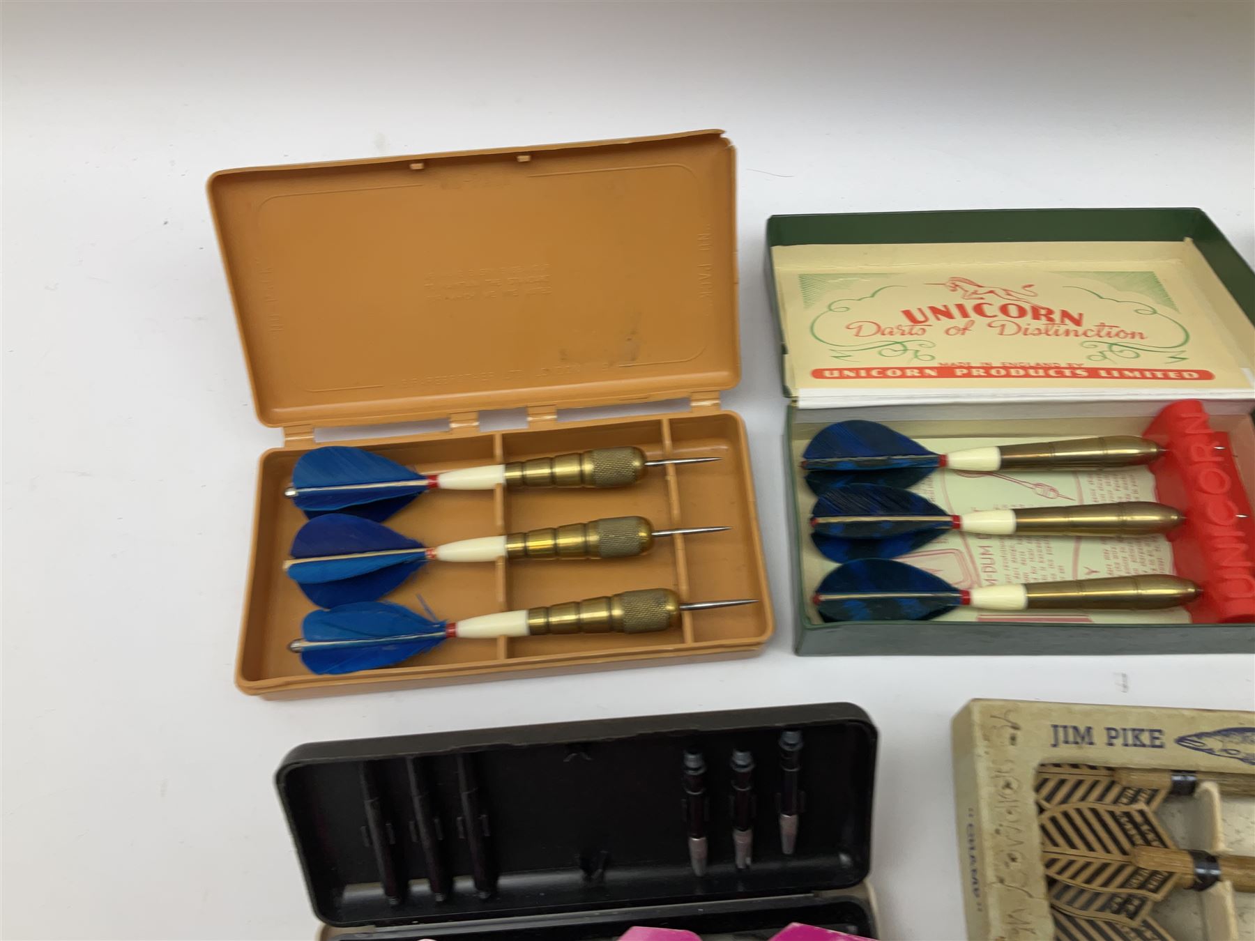 Nineteen sets of dartboard darts by Unicorn, Jim Pike, 'One-o-One', Farebrother etc, with various flights, shafts, styles and weights; predominantly boxed