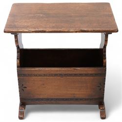 Oak magazine rack or side table, rectangular top on shaped end supports and sledge feet, panelled sides with chip carved decoration 