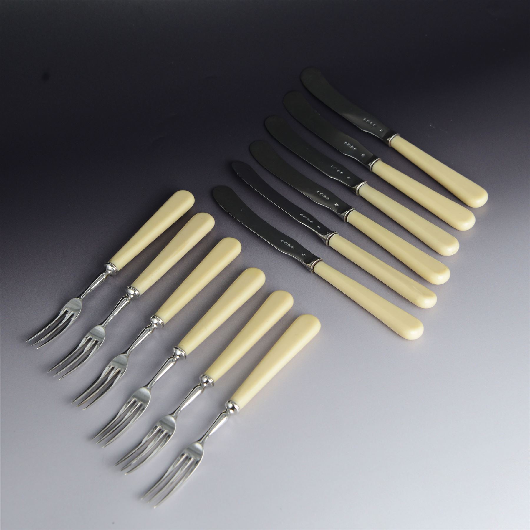 Set of six Victorian silver dessert knives and forks, with ivorine handles, hallmarked William Hutton & Sons (Edward Hutton), London 1880