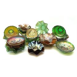 A collection of Carnival glass, to include marigold, green, and amethyst, bowls, dishes, and comports, various patterns including fruiting vines, peacocks, and an example decorated with a Horseshoe and detailed Good Luck. 
