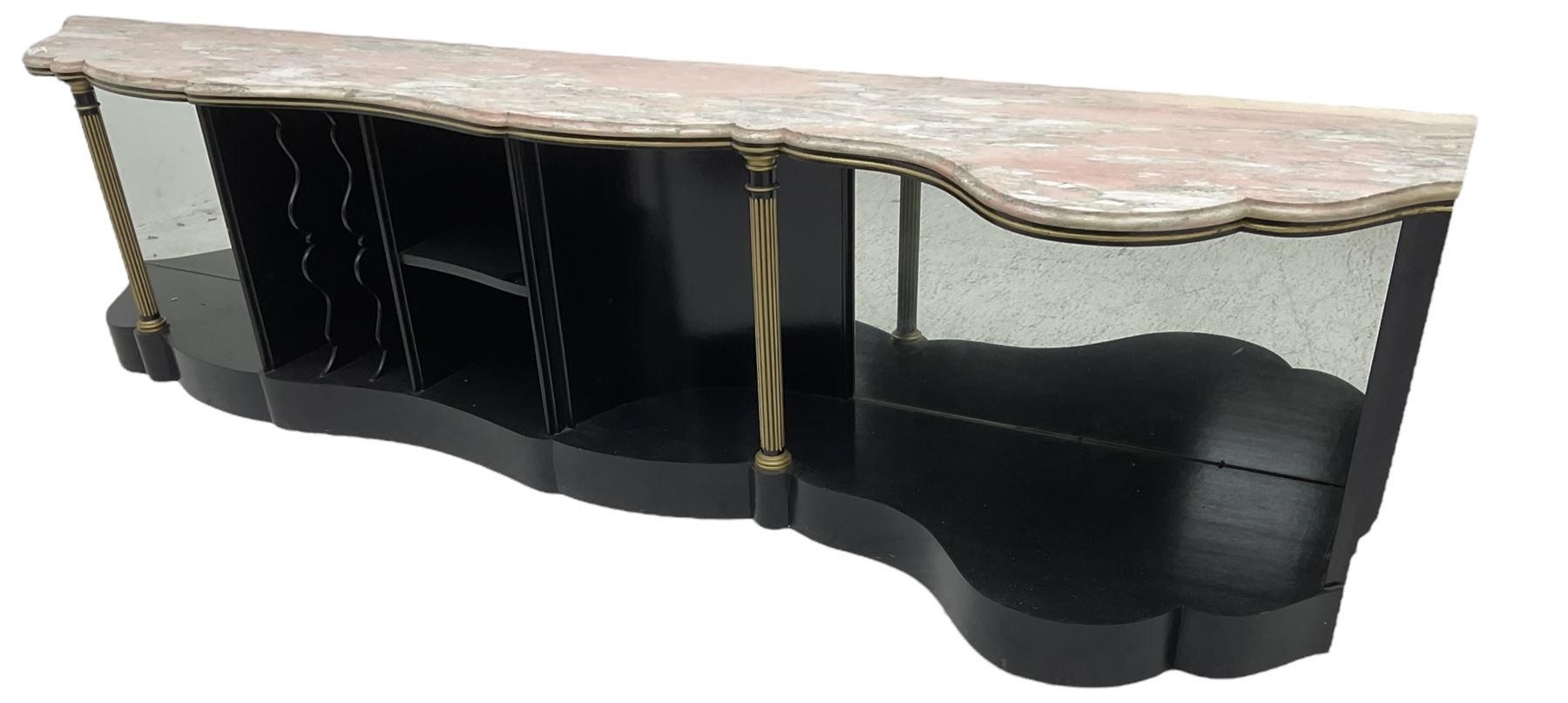 Italian ebonised and gilt serpentine corner console bookcase cabinet, shaped pink marble top over assorted shelves and dividers with fluted pilasters and mirror backs, on skirted base 