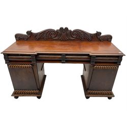 Early 19th century figured mahogany twin pedestal sideboard, fitted with raised back above four frieze drawers, two cupboards with scallop moulding