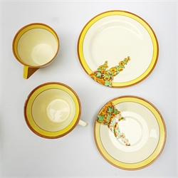 A Clarice Cliff Bizarre by Wilkinson Limited dinner plate, trio and cup in the Sunshine pattern. (5).