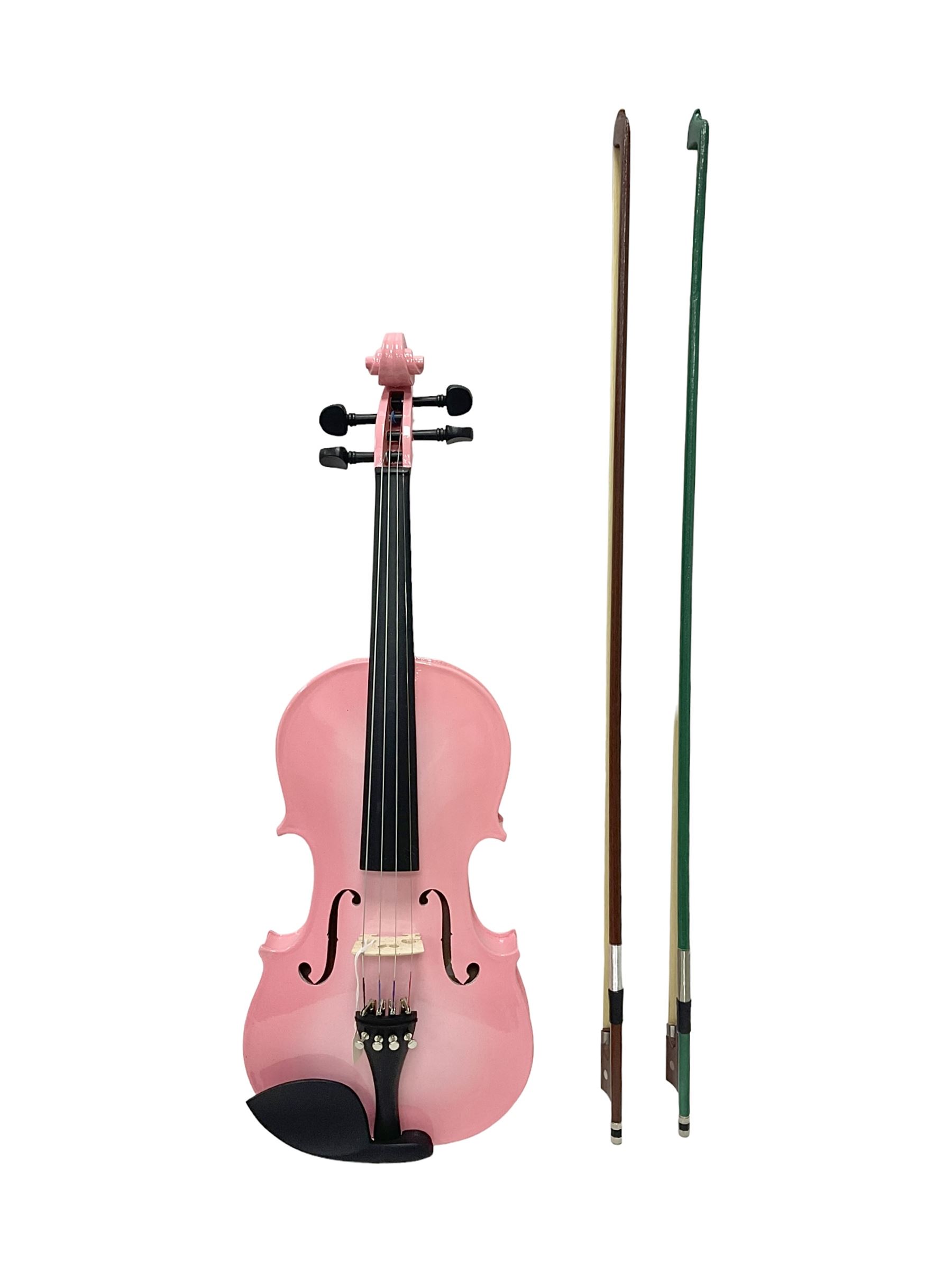 Zest full size pink violin, with a solid wood body and maple head, with matching pink bow and two further bows, in a hard case Length 60cm