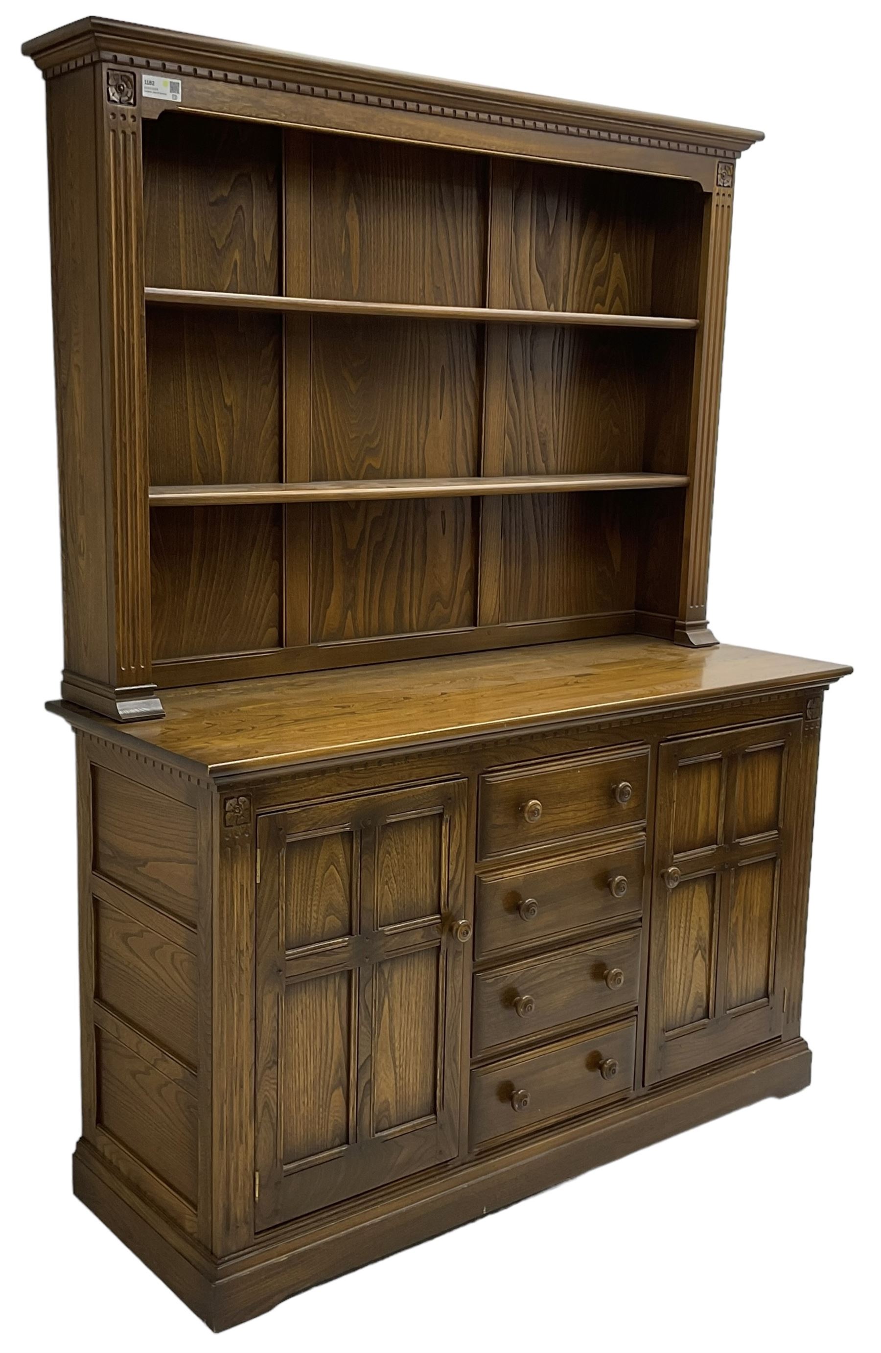 Ercol - mid-20th century dark elm 'Old Colonial' dresser, two tier plate rack with fluted uprights, base fitted with four drawers flanked by two panelled cupboards