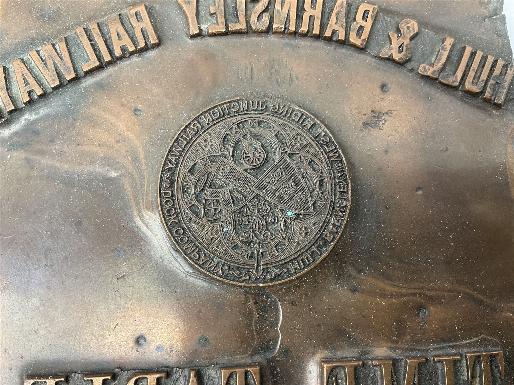 Three brass cart wheel hub caps for W. Johnson & Son Builders Hull, another for W. Harrison Builder Hull, copper printing plate for Hull & Barnsley Railway Timetable, two Hull & District Road Transport Training Group Advanced Driver car badges and framed 1952 car road task disc (8)  