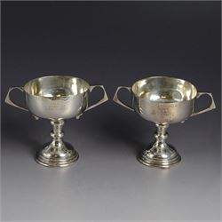 Pair of 1920s silver twin handled trophies, each with presentation engraving, hallmarked M...