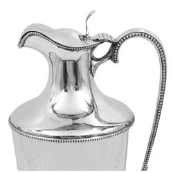 Early 20th century silver mounted claret jug, the plain tapering glass body with silver collar, pierced thumb piece, elongated handle and beaded borders, raised upon conforming domed foot, including thumbpiece H28.3cm, hallmarked Goldsmiths & Silversmiths Co Ltd, London 1912 