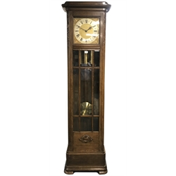  Early 20th century oak longcase clock, the case with astragal bevel glazed door and scrolling foliage carved decoration, triple brass weight driven chiming 'Gustav Becker' movement, with Wittington, silent and Westminster lever adjust, silvered chapter ring with Roman numerals, H204cm  