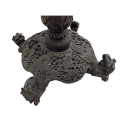 Late 19th century Anglo-Indian carved hardwood occasional table, circular tilt-top carved profusely with mythical animals and foliage decoration, pierced and carved with interlaced leafy branches, leaf carved pedestal supports on a raised platform with further carved and pierced foliage decoration, four carved feet in the form of mythical beasts with gaping jaws 