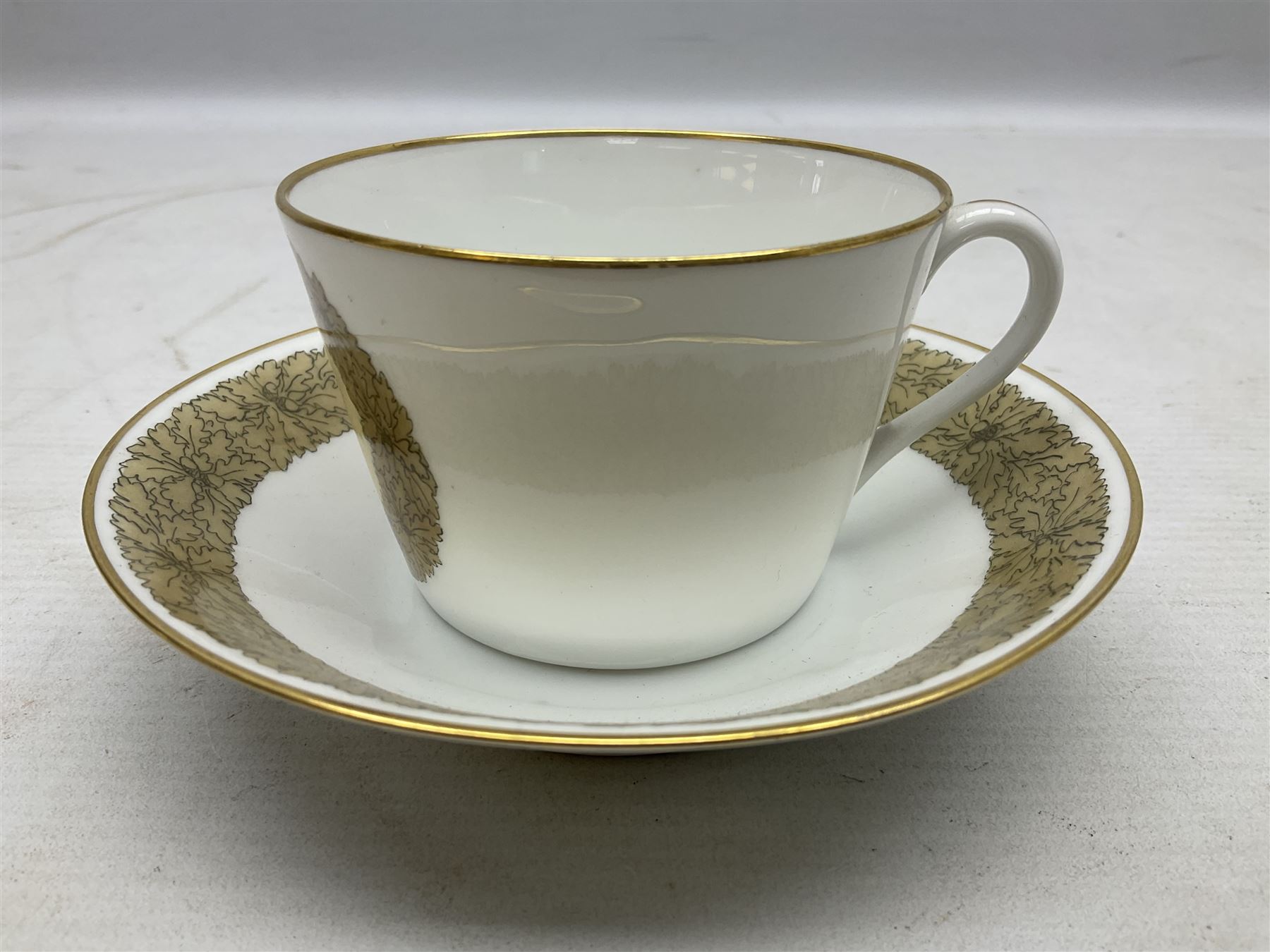WW2 Nymphenburg cups and saucer, decorated with Imperial German Iron Cross encircled in a foliate boarder with gilt edging, with printed mark beneath 