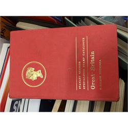 Stamp and coin reference materials, including Stanley Gibbons 2023 'Great Britain Concise' stamp catalogue, various editions of 'The Postal Stationary Society', empty stamp albums etc, in two boxes