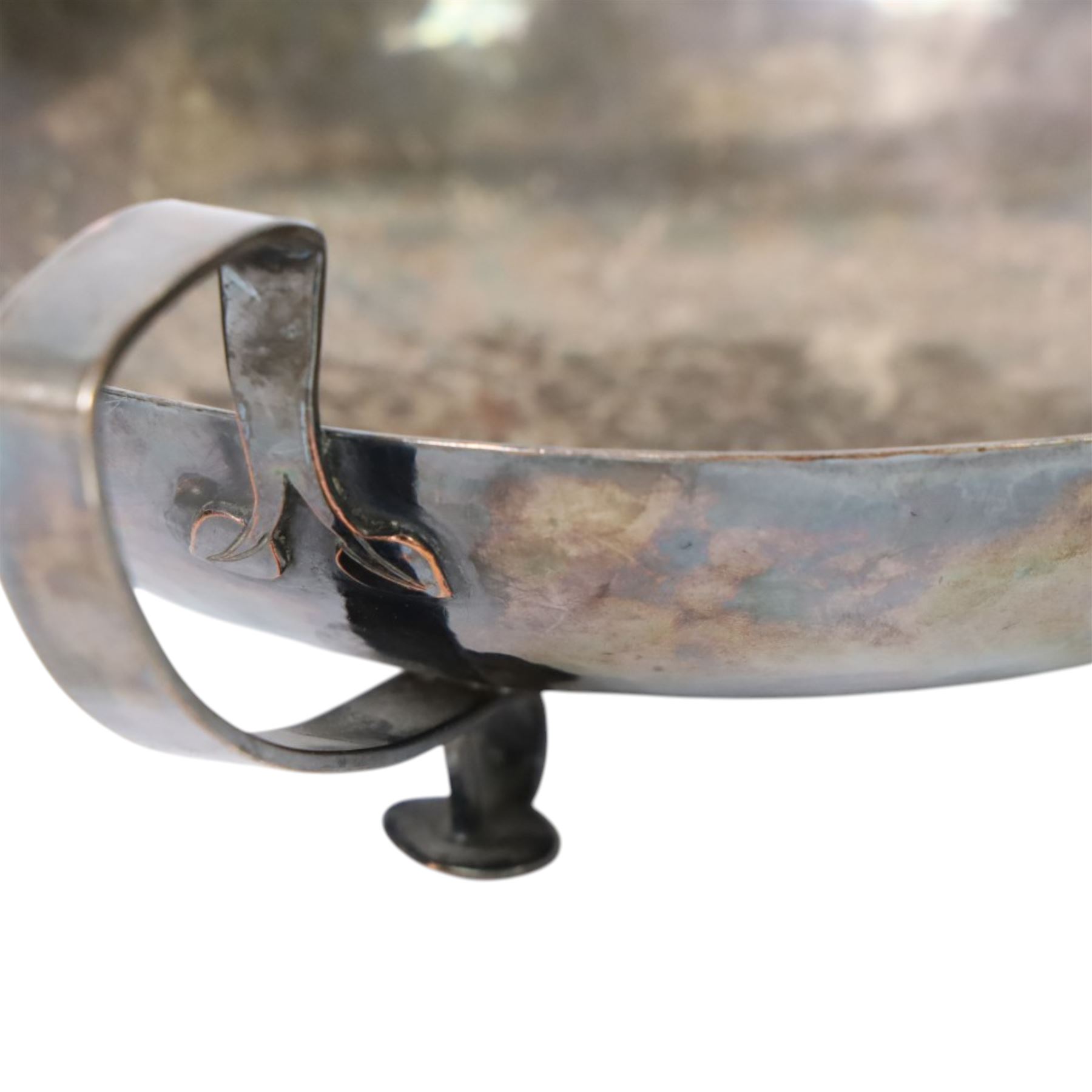 The Keswick School of Industrial Art, three stem bowl, the bowl supported upon three strapwork handles finished in leaf designs, marked beneath Keswick C196, H9cm D21cm