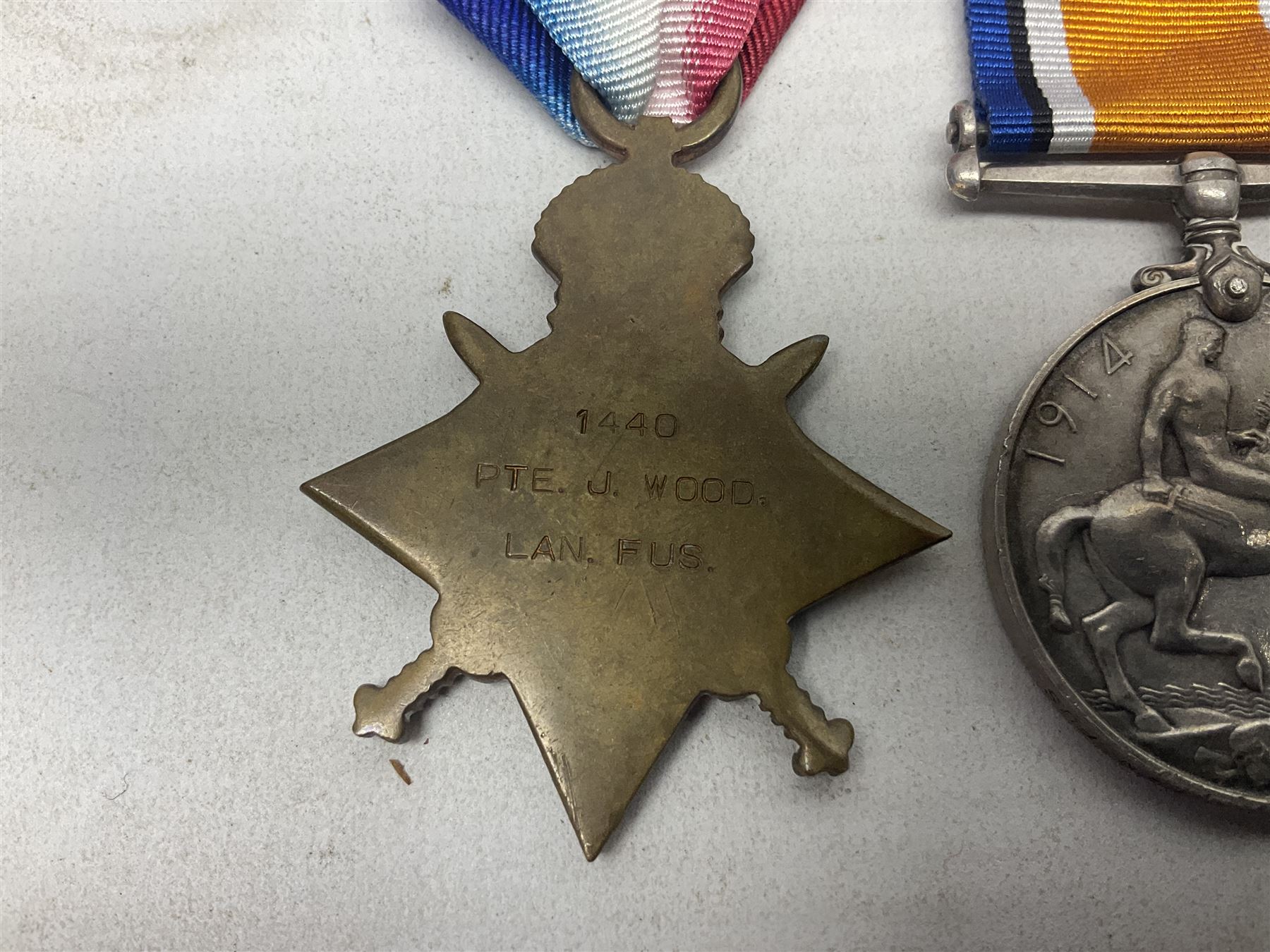 WW1 pair of medals comprising British War Medal and 1914-15 Star awarded to 1440 Pte. J. Wood Lan. Fus.; and WW1 Victory Medal awarded to 12128 Bmbr. R. Phillips R.A.; all with ribbons (3)